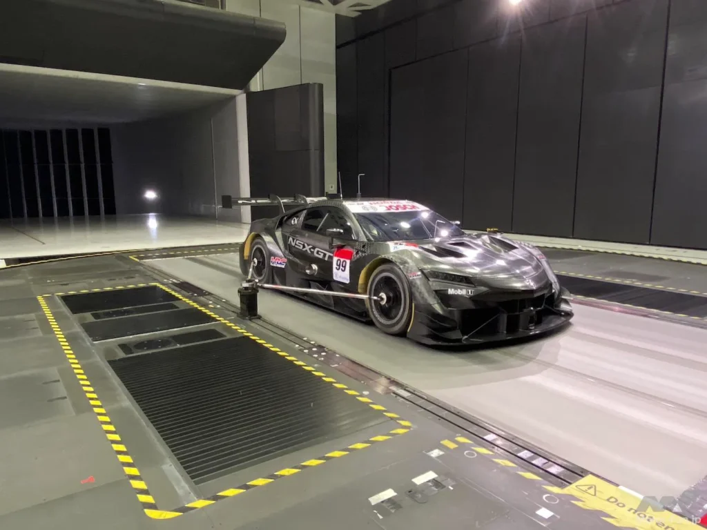 Perspective view of a black Honda NSX-GT in Honda’s full scale wind tunnel in Sakura.