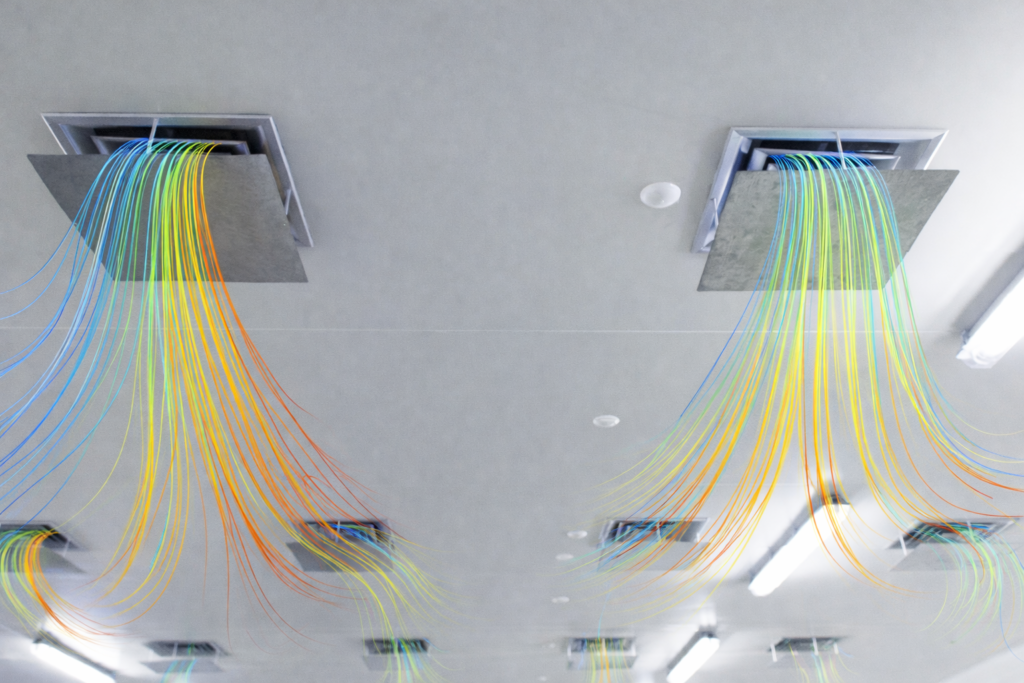 CFD simulation of HVAC system showing coloured airflow streamlines exiting ceiling air diffusers in an indoor environment